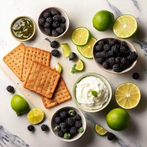 Fresh ingredients for Blackberry Lime Lush, including blackberries, limes, graham crackers, and cream cheese.