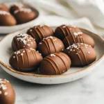 Homemade peanut butter eggs beautifully presented on a white plate